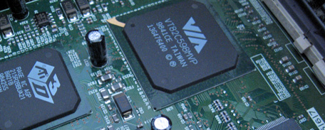 Photo close up of a motherboard's circuitry.